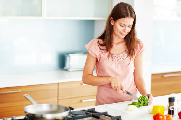 istock An attractive young female cooking in the kitchen 117146202