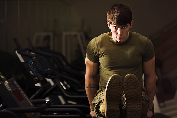 One man, fit young man warming up before training in gym alone.