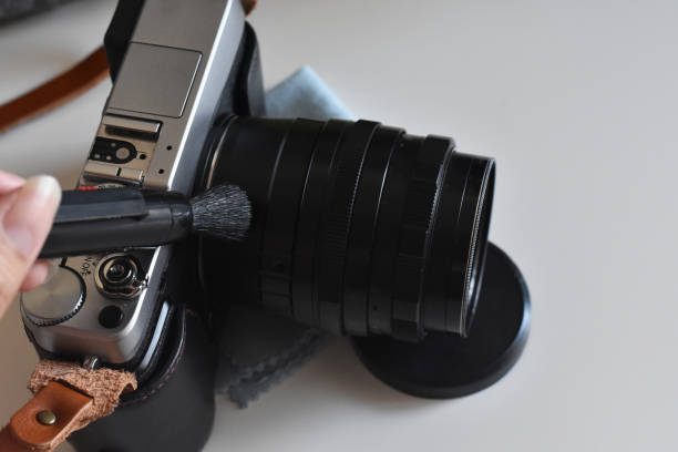 istock Using brush cleaning dust out of camera. 1171463082