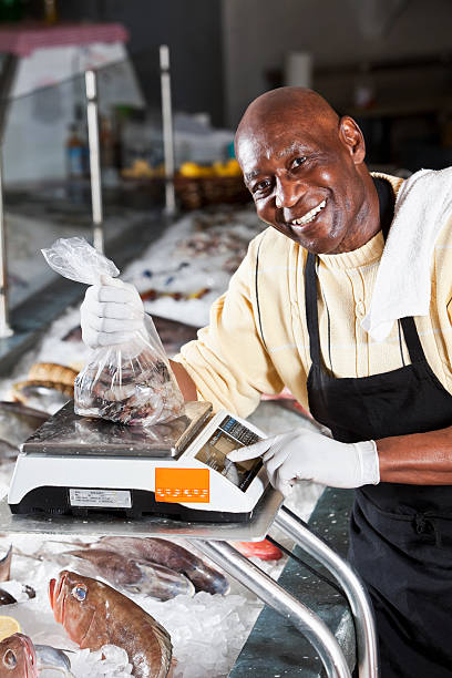 istock Worker behind counter in fish market 117146459