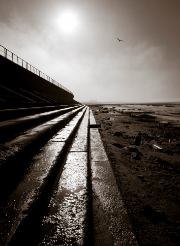 Backlit of stairs. On the background a factory. Severn Beach, Bristol, UK. Grainy due to digital noise.