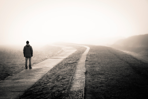 lonely man loosing the way on a foggy day.