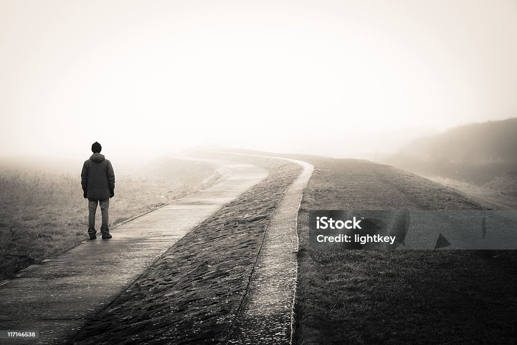 Lost man lonely man loosing the way on a foggy day. Loneliness Stock Photo