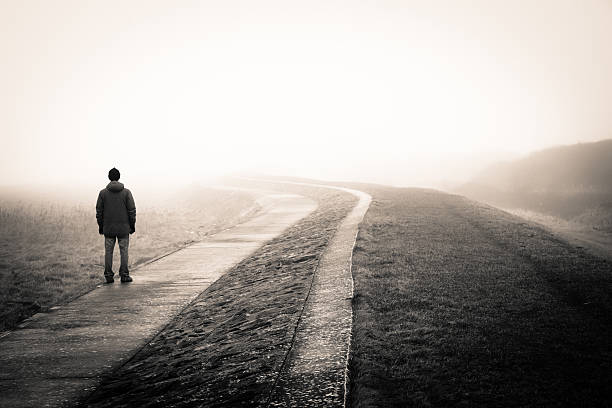 Lost man lonely man loosing the way on a foggy day. solitude stock pictures, royalty-free photos & images