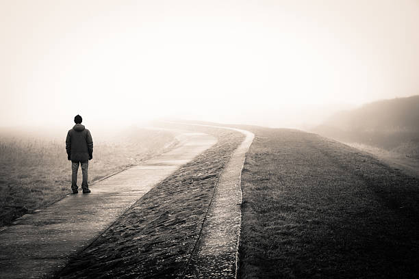 Lost man lonely man loosing the way on a foggy day. remote location stock pictures, royalty-free photos & images