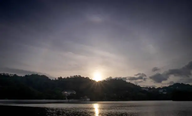 Photo of Amazing sun halo above the lake at the center of Kandy city, Sri Lanka.