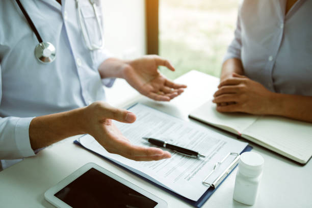 istock Confident doctor man holding a pill bottle and writing while talking with senior patient and reviewing his medication at office room. 1171467877