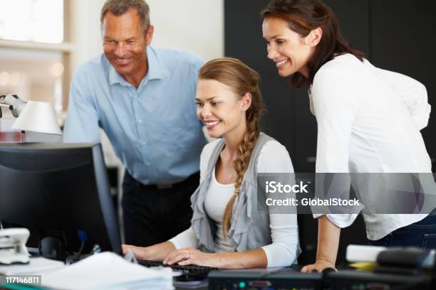 Happy Business Employees Looking At Computer Monitor Stock Photo - Download Image Now