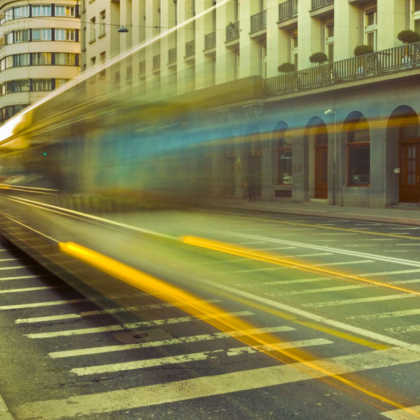 Long exposure shot of an old street with moving traffic at sunset.
