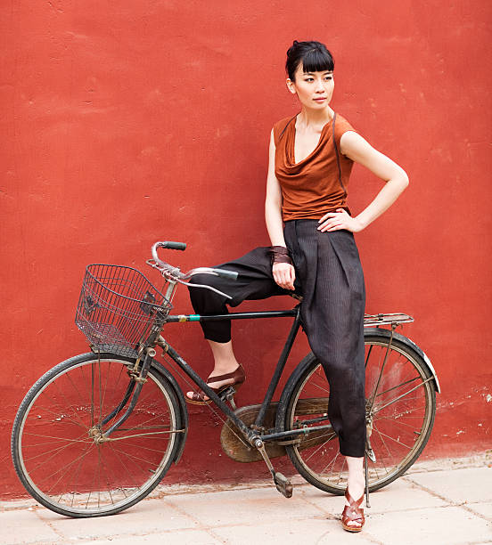 istock Young asian woman posing sitting on bicycle 117146945