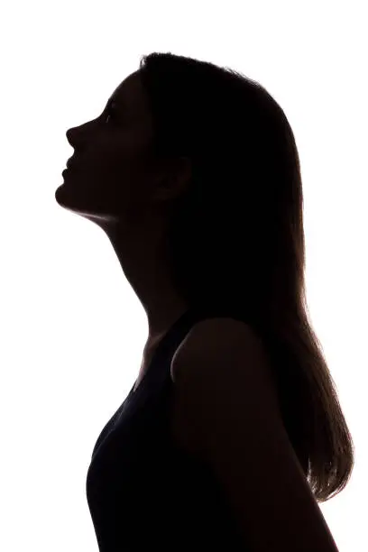 Photo of Young woman looking up - vertical silhouette