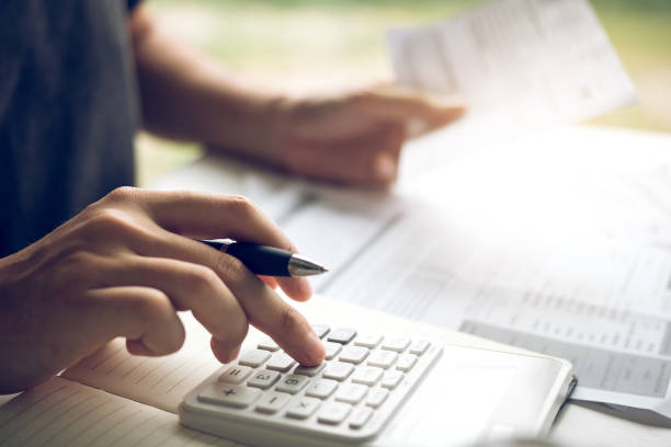 istock Man use calculators and documents that calculate expenses in the home office. 1171470888