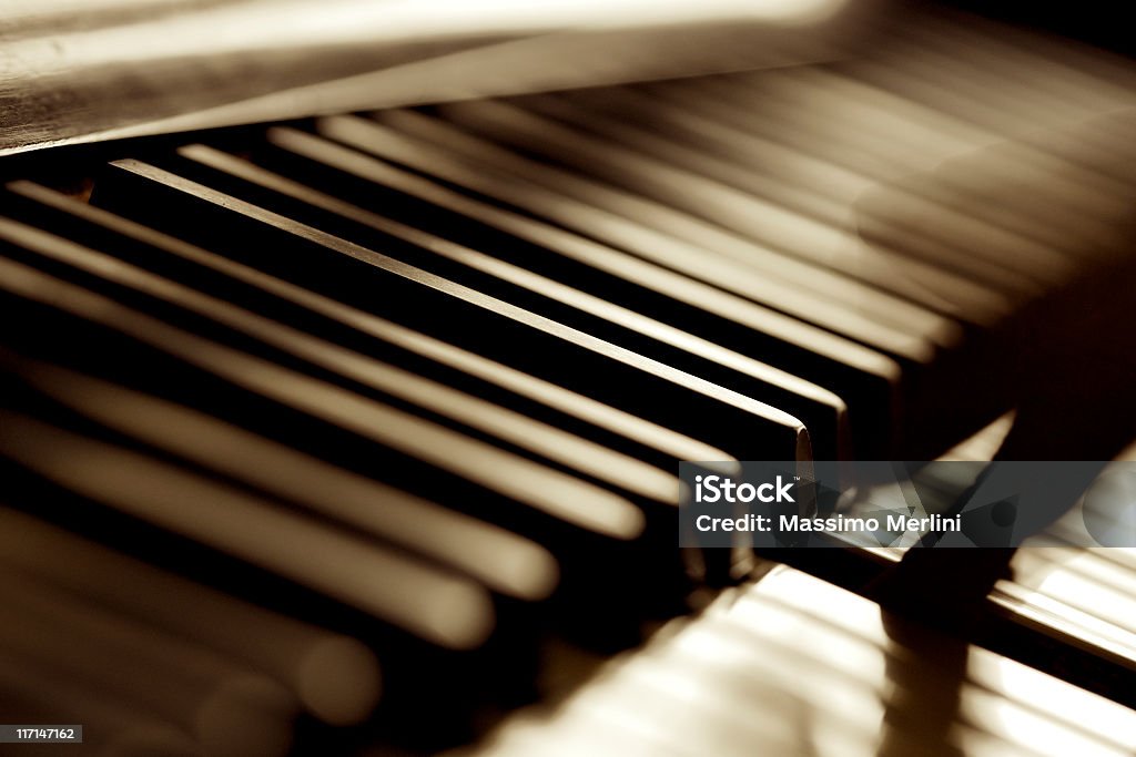 Musician Play Piano Musician play piano in daylight. Back Lit. Selective focus. Sepia toned. http://www.massimomerlini.it/is/music.jpg Activity Stock Photo