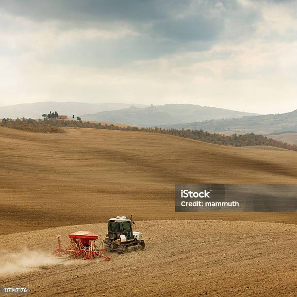Caterpillar Tractor Pulling Seeder And Harrow Stock Photo - Download Image Now - Cloud - Sky, Cloudscape, Hill