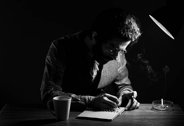 Portrait of Poet writing on table in the dark  author stock pictures, royalty-free photos & images