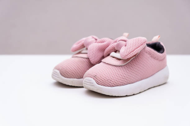 istock Pink baby sneakers on a white background, copy space 1171473232