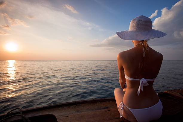 istock Woman looking into the sunset from a boat 117147334
