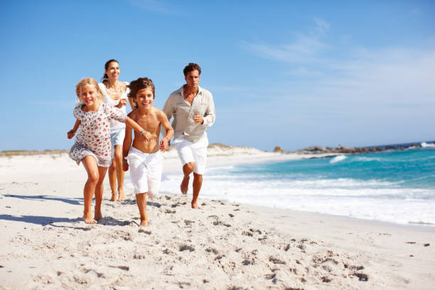 istock Boy racing girl on beach 117147534