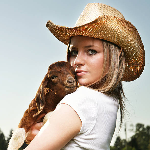 istock Woman Holding Baby Goat 117147638