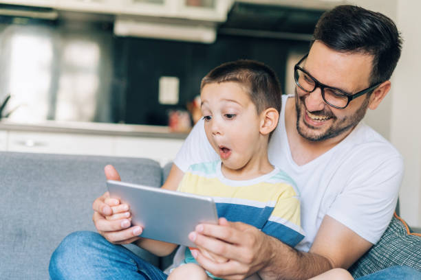 istock Father and son looking at digital tablet 1171476904