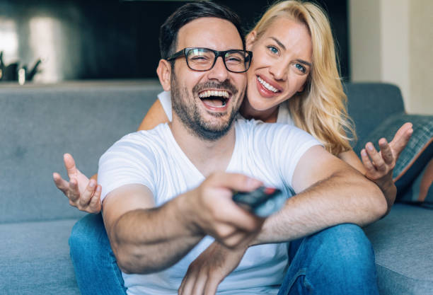 istock Happy couple watching tv 1171476905