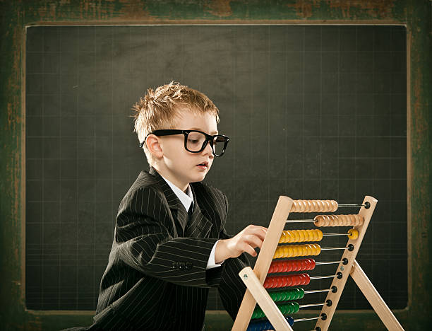 istock young serious scientist child with abacus and copyspace blackboa 117147752