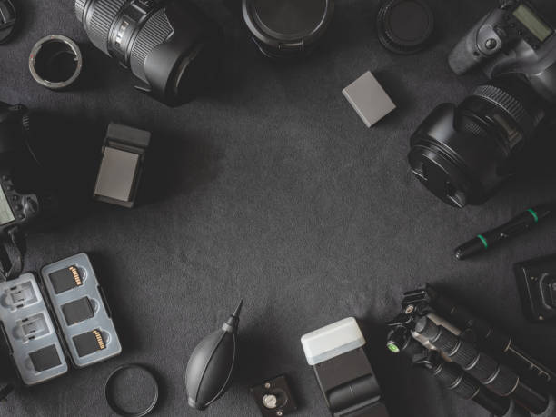istock top view of work space photographer with digital camera, flash, cleaning kit, memory card, tripod and camera accessory on black table background 1171477631