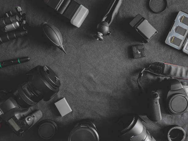 istock top view of work space photographer with digital camera, flash, cleaning kit, memory card, tripod and camera accessory on black table background 1171477652