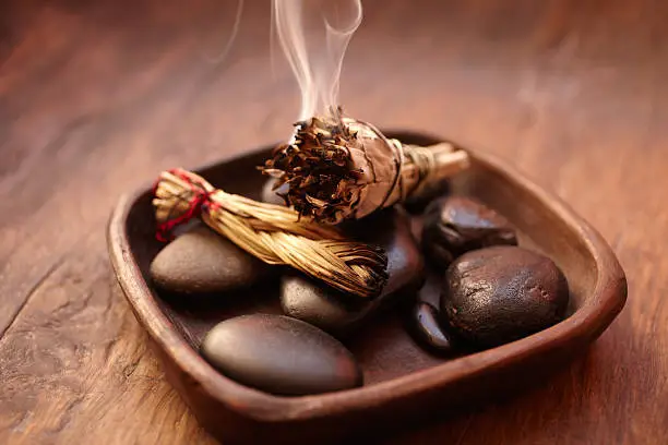 Burning incense Sage stick and pebbles