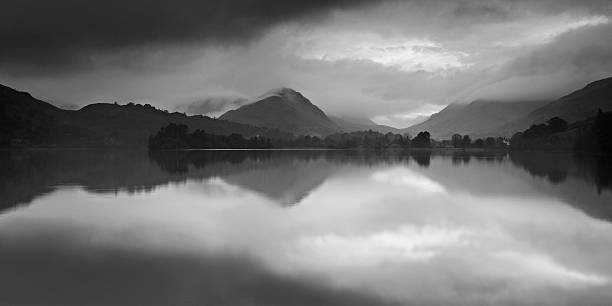 istock Dramatic Storm Clouds over Mountain Lake at Dawn 117148092