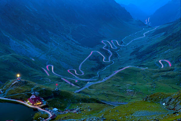 istock Car lights on mountain long exposure 1171481641