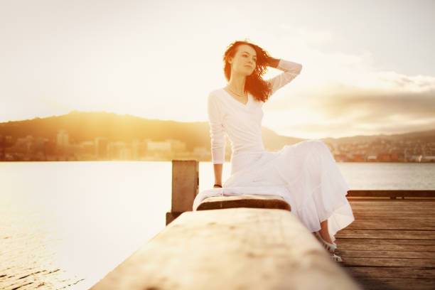 Tourists wearing white dresses at the beach