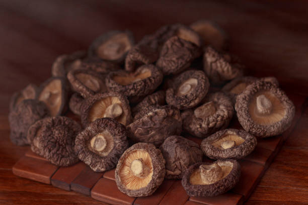 istock dried mushrooms lie on a wooden dark colored surface 1171482550