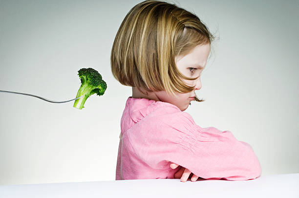 Young Girl Refusing To Eat Her Greens