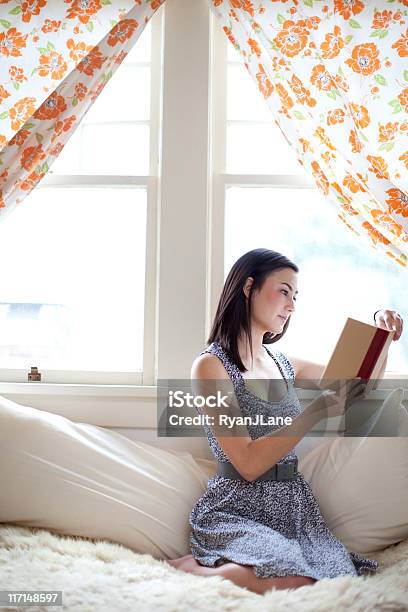 Mujer Joven Estudiante Leer Por La Ventana Foto de stock y más banco de imágenes de Dormitorio - Residencia estudiantil - Dormitorio - Residencia estudiantil, Adulto, Adulto joven