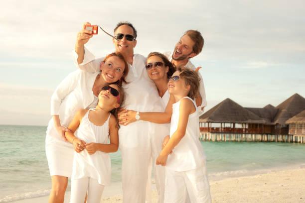 istock happy tourists making a snapshot on the beach 117148680