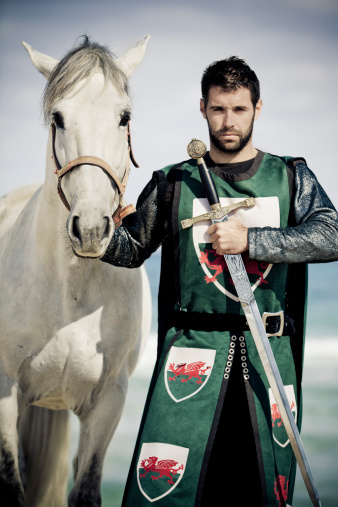 portrait of dramatic looking knight with white stallion, selective focus, very creative color retouching to underline the ancient medieval time,vignetting 