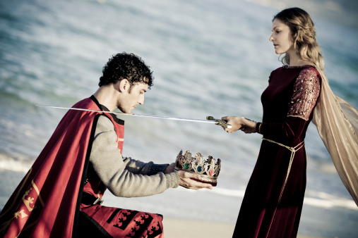 portrait of medieval queen in flashy satin dress knighting  the king for novel concepts,selective focus, creative dramatic color retouching to underline the ancient medieval time,vignetting see more: