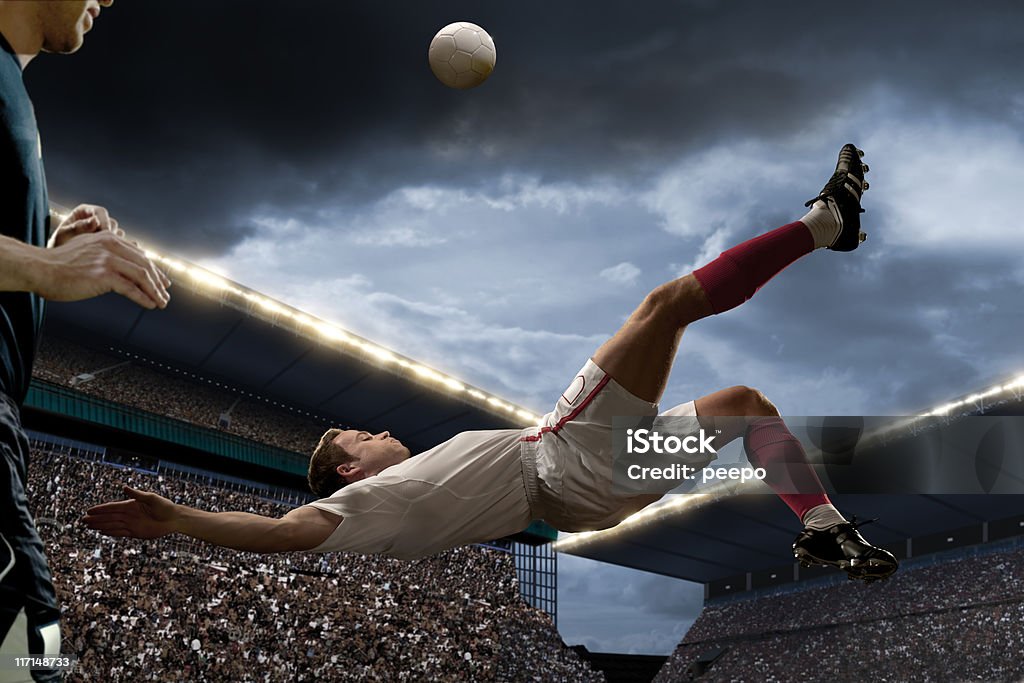 football player doing overhead kick  Bicycle Kick Stock Photo