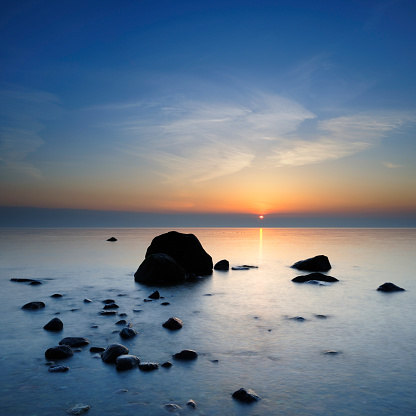 Tranquil Seascape with Huge Boulders at Sunrise