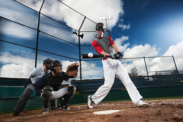 istock Athletic Baseball Player Hitting Ball with Catcher and Umpire, Copyspace 117148928