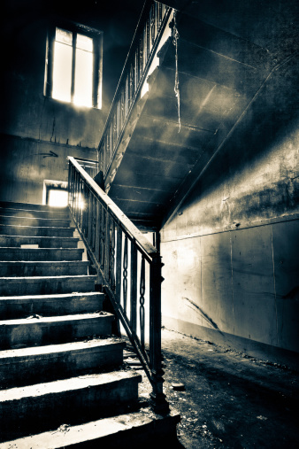 The Ghost House: interior of an abandoned house, very dirty and messy, with rotten walls and staircases.