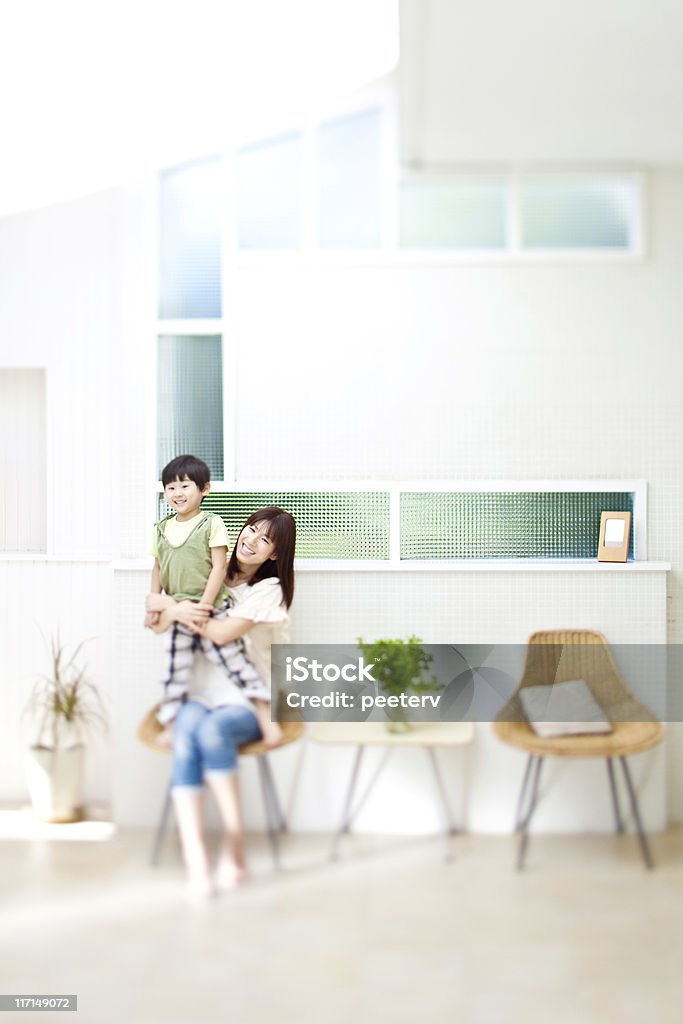 smiling family japanese boy with her mother in bright modern room. Asia Stock Photo