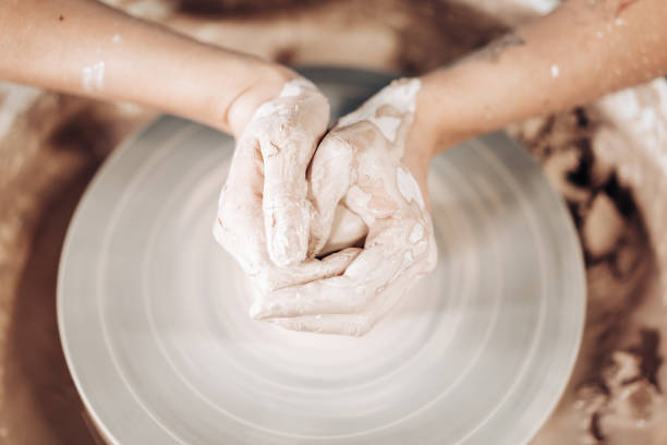 istock Working process of man's work at potters wheel in art studio. Unknown craftsman creates jug. Focus on hands only. Small business, talent, invention, inspiration concept. 1171490969