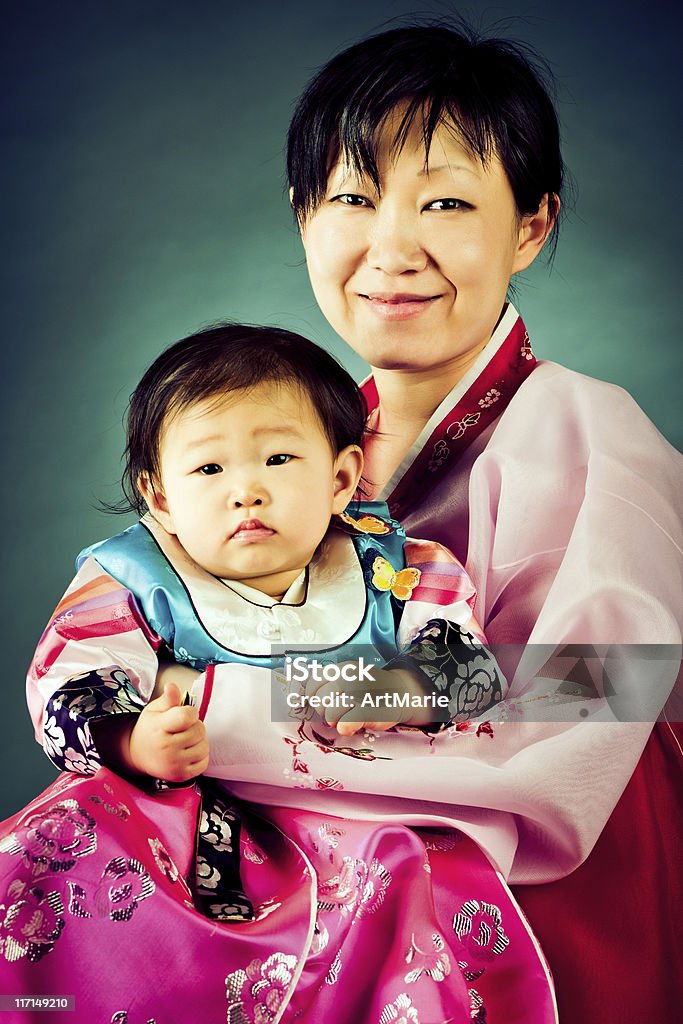 Korean baby girl and her mother in traditional hanbok Studio shot of cute little Korean baby girl and her mother dressed in traditional hanbok. Korea Stock Photo