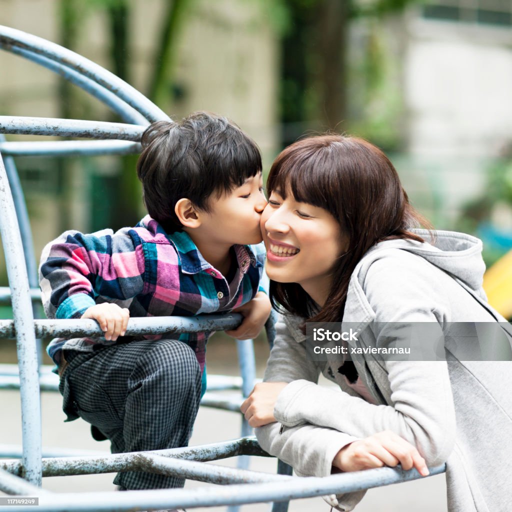 Love Japanese boy kissing his mother. 30-39 Years Stock Photo