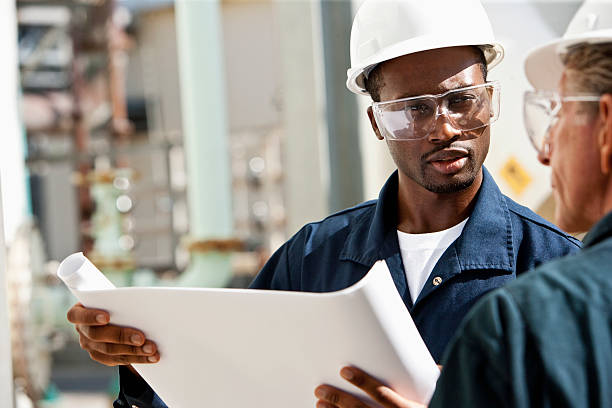 lavoratori industriali rivedere i progetti - manufacturing occupation african descent refinery manual worker foto e immagini stock