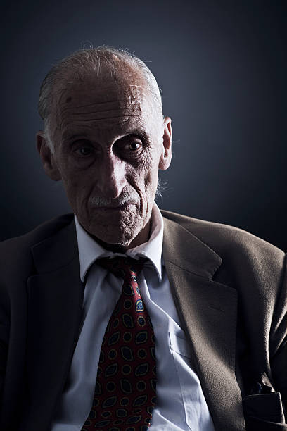 istock Old man in dark ambience looking sideways. 117149364