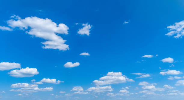 white fluffy clouds floating in the bright blue skies - 12007 imagens e fotografias de stock