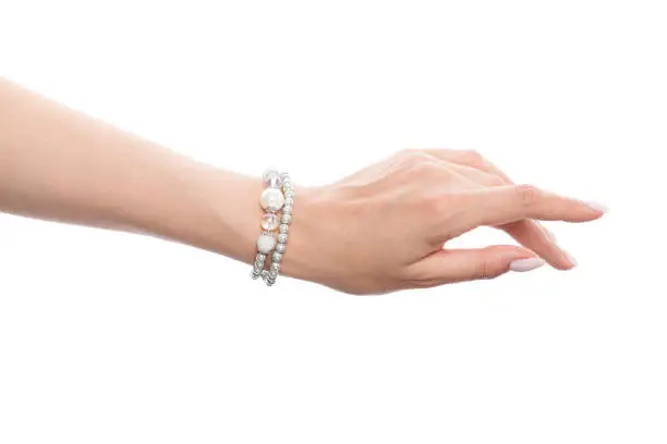 Hand wearing silver jewelry bracelet isolated on white background